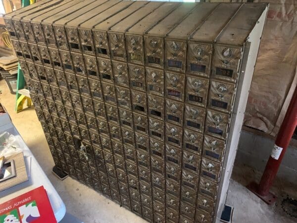 A large amount of mail boxes stacked on top of each other.