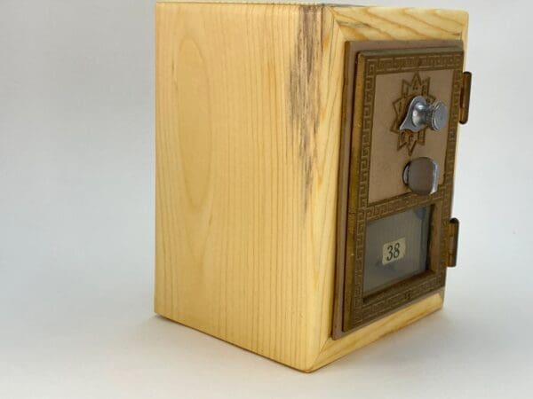 A wooden box with a combination lock on top of it.