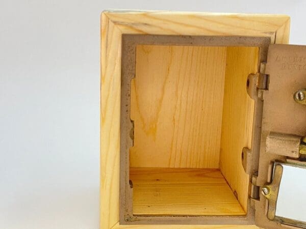 A wooden box with a small opening on the side.