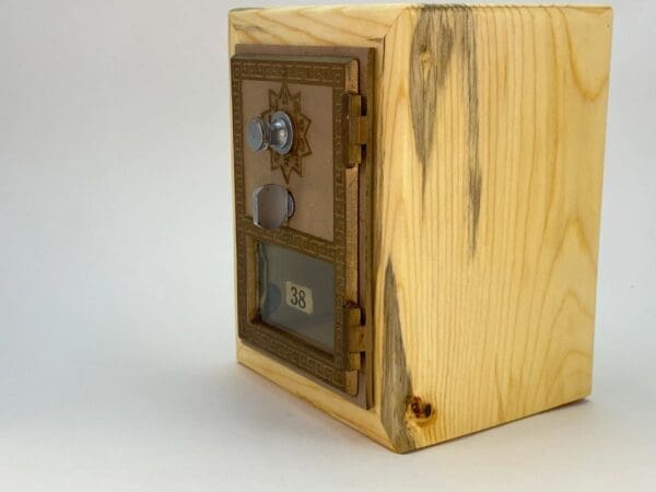 A wooden box with a metal door on top of it.