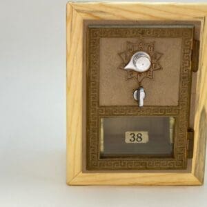 A wooden box with a key and a clock on it.