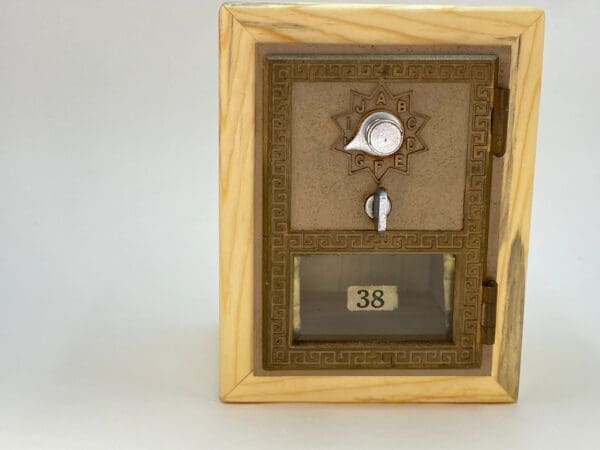 A wooden box with a key and a clock on it.