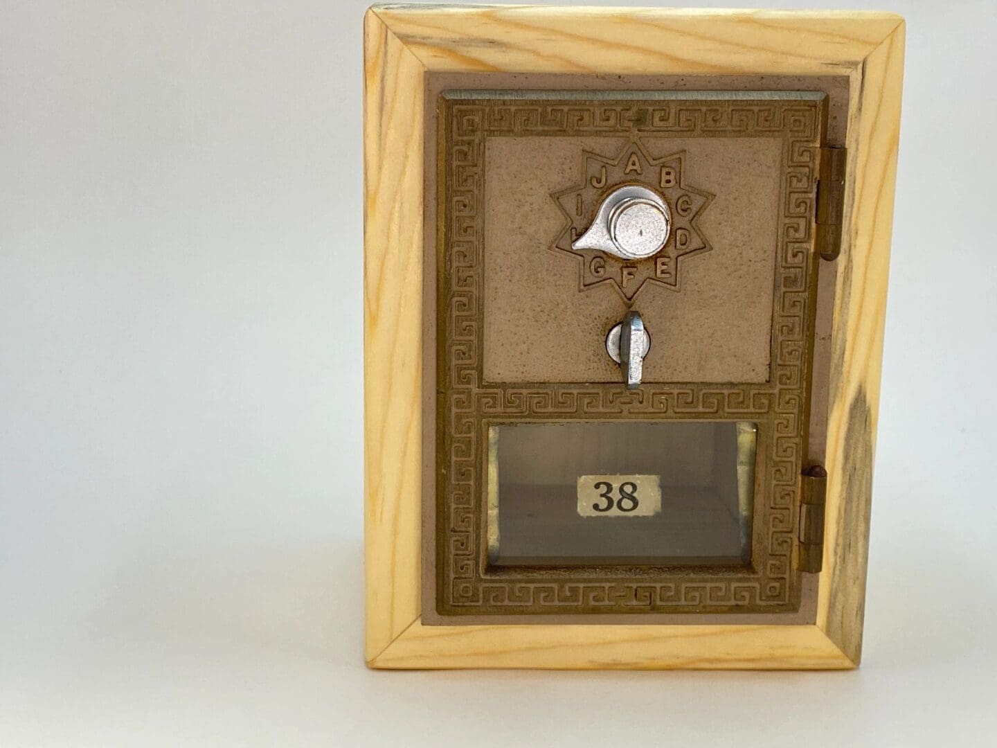 A wooden box with a key and a clock on it.