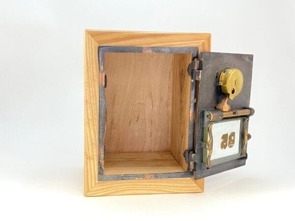 A wooden box with a door open to reveal a small clock.