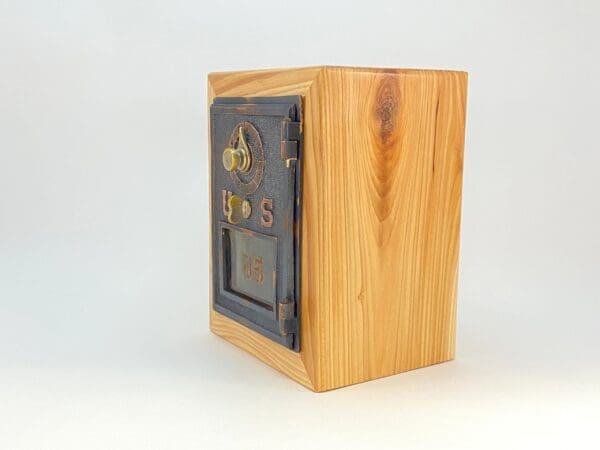 A wooden box with a metal door on top of it.