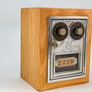 A wooden box with a metal door and numbers on it.