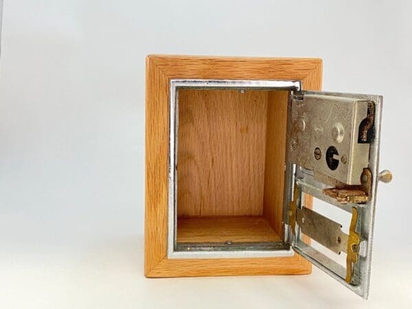 A wooden box with a metal door open.