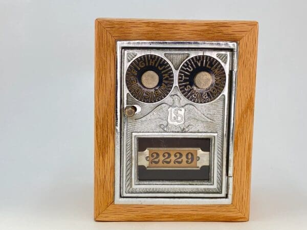 A wooden box with a clock on top of it.