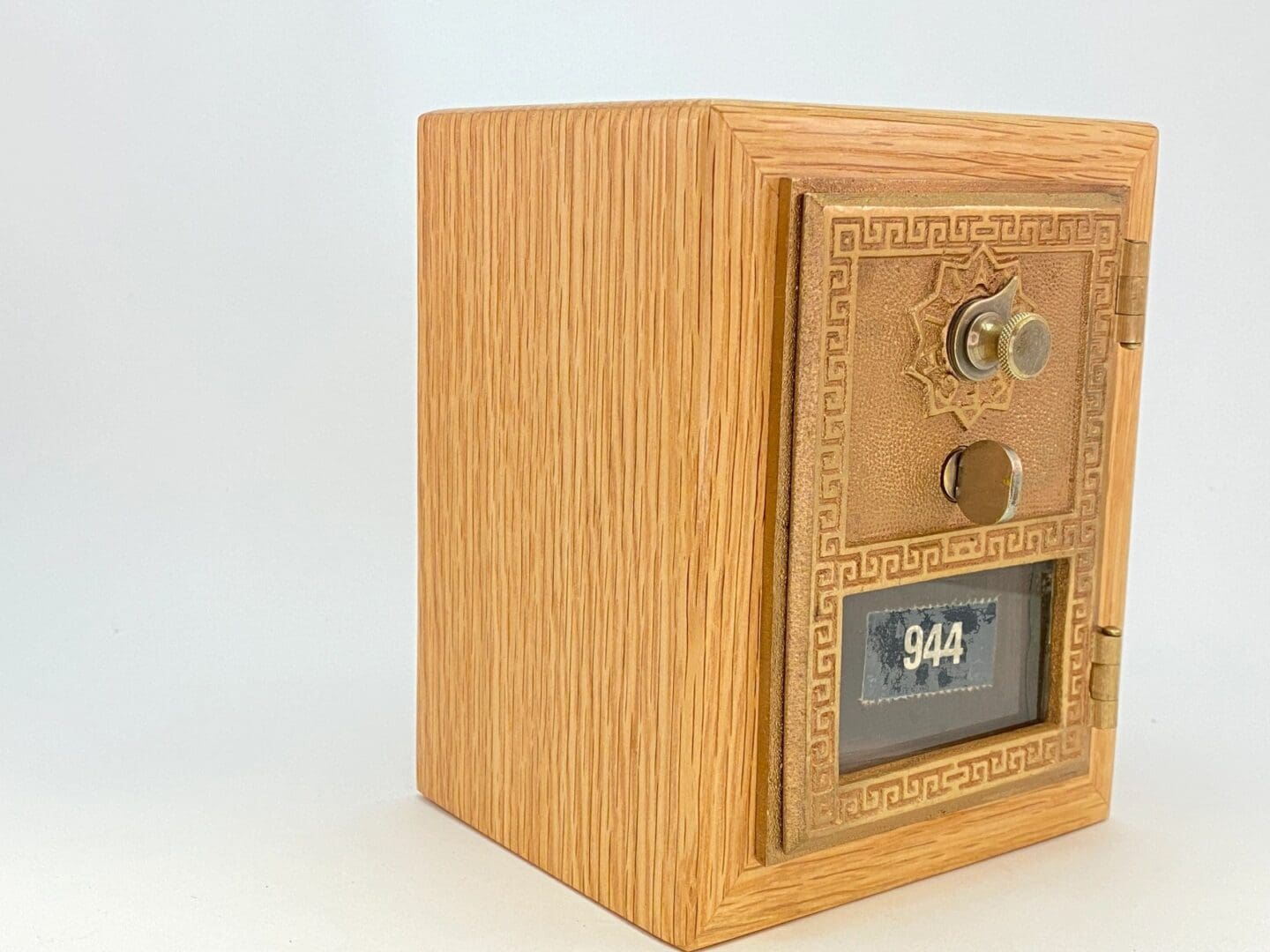 A wooden safe with the door open.