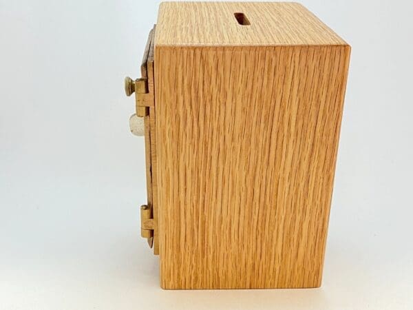 A wooden box with a slot for coins.