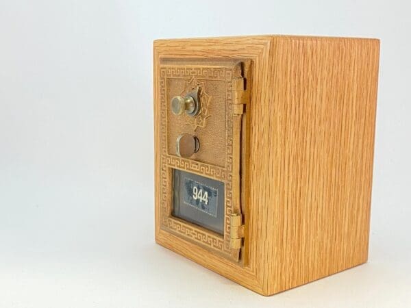 A wooden box with a combination lock on top of it.