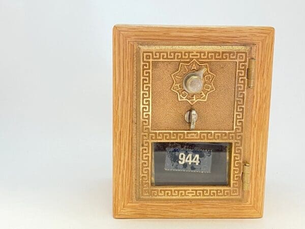 A wooden box with a clock on top of it.