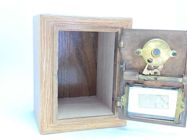 A small wooden box with a mirror inside of it