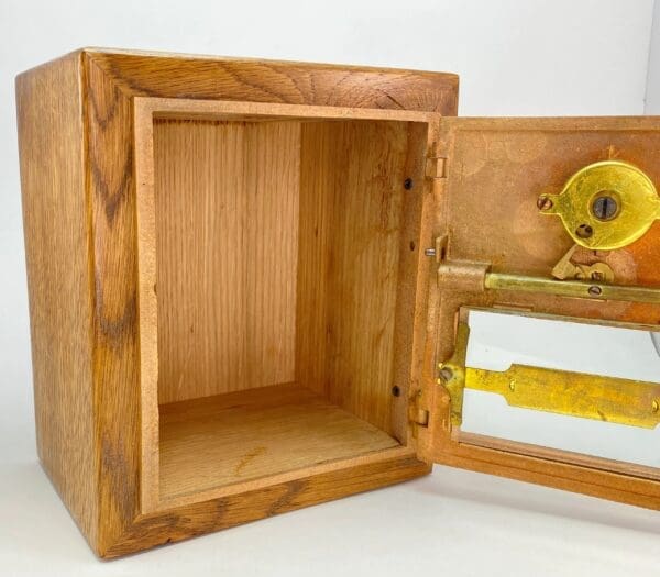 A wooden box with a yellow handle and a lock.