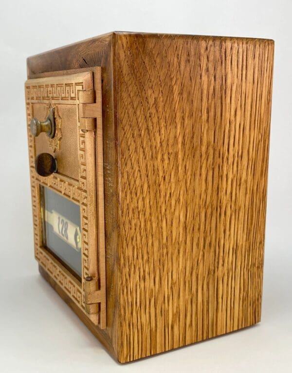 A wooden box with a clock on top of it.