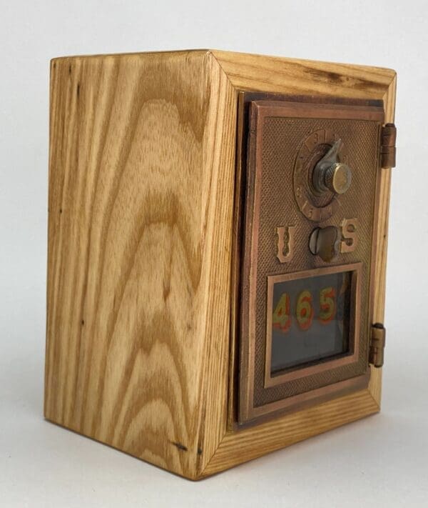 A wooden box with a clock on top of it.