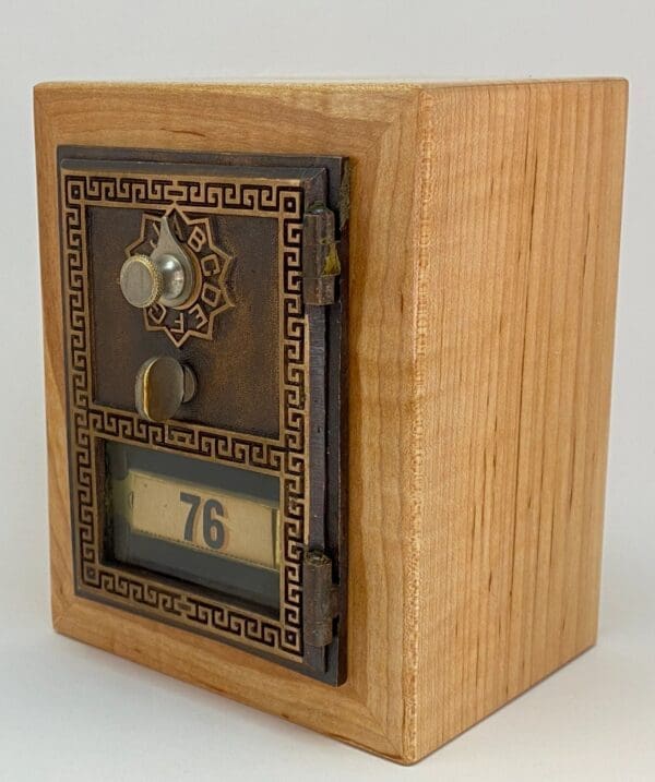 A wooden box with a clock on the front.