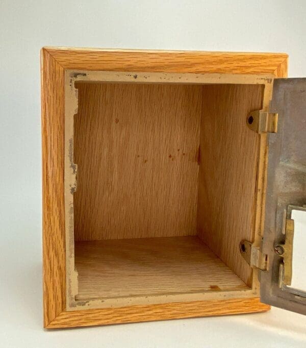 A wooden box with an open door on top of it.