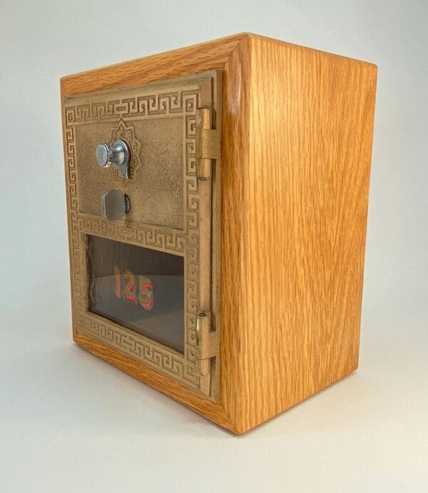 A wooden box with a door and window.