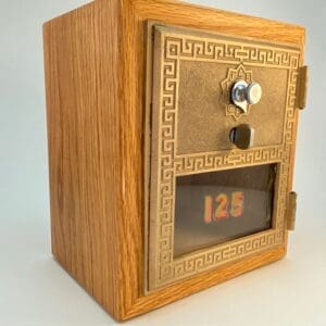 A wooden box with a door and the number 1 2 5 on it.