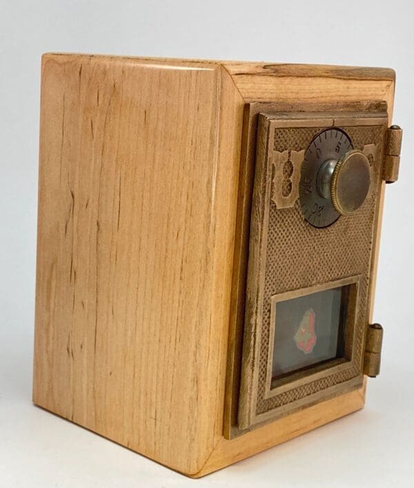 A wooden box with a lock and key on top of it.