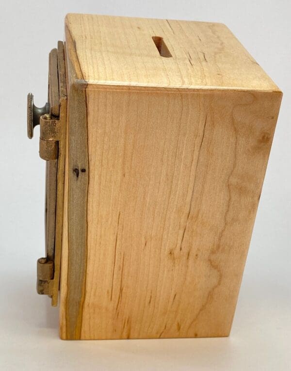 A wooden box with a lock on top of it.