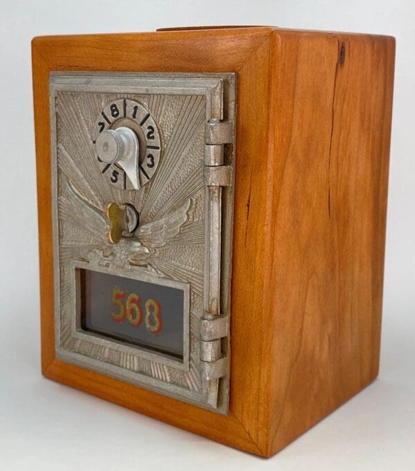 A wooden box with a metal door and the number 6 6 on it.