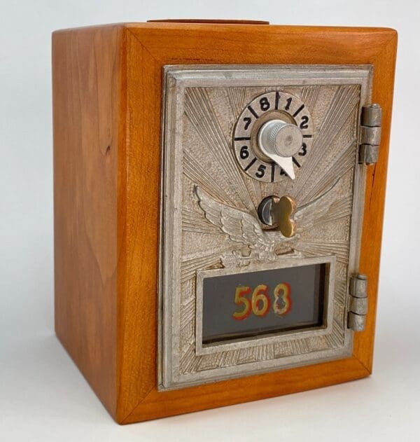 A small wooden box with a clock and numbers on it.