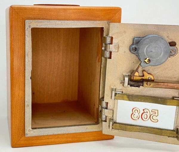 A wooden box with a lock and key inside.