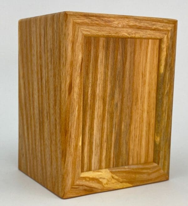 A wooden box with a small window in it.