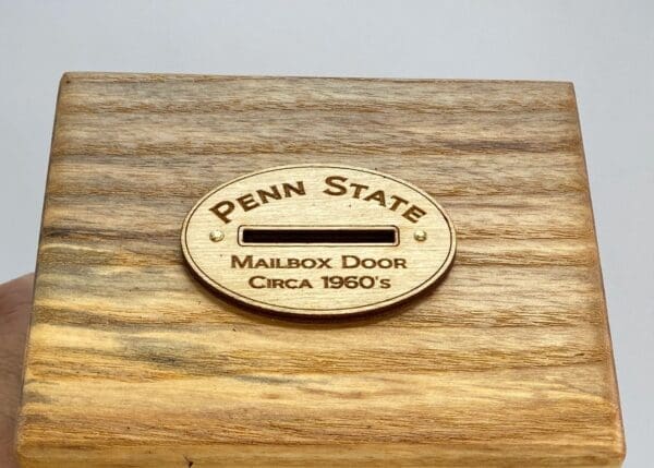 A wooden box with the penn state logo on it.