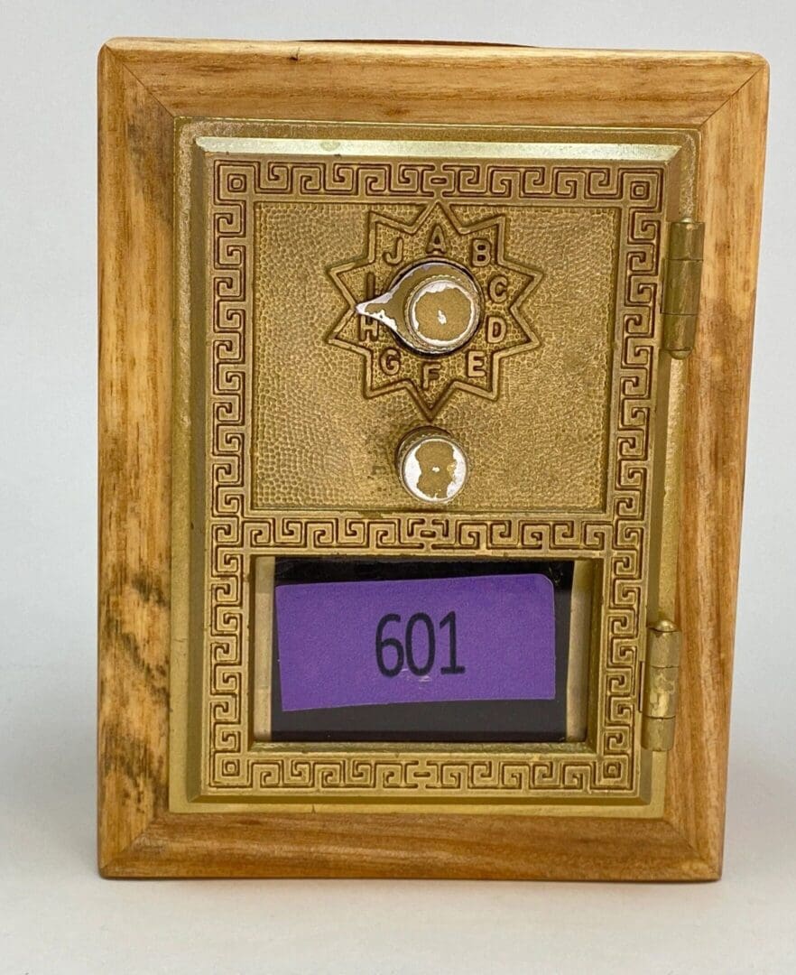 A wooden frame with a clock and a purple sign.