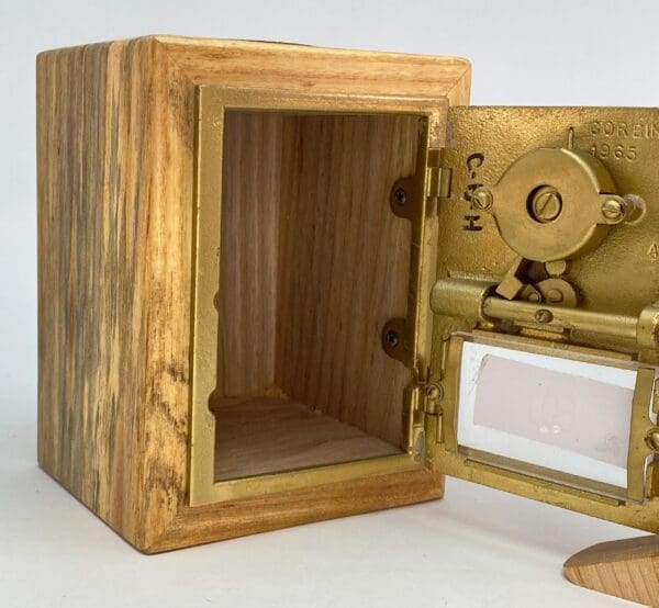 A wooden box with a small door open.