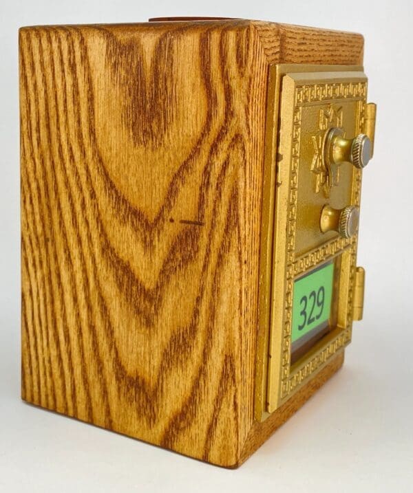 A wooden box with a gold trim and a clock.