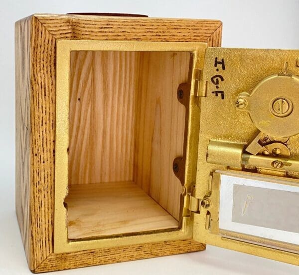 A wooden box with a door open and the inside of it.