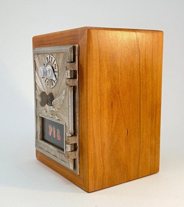 A wooden box with a clock on top of it.