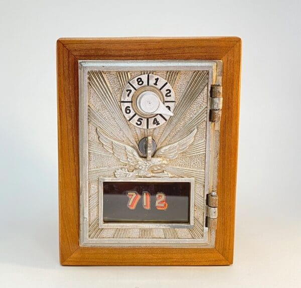 A wooden box with a metal door and a picture of marijuana leaves.