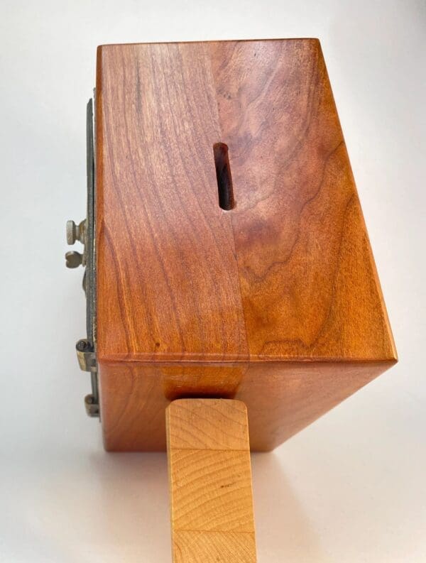 A wooden box with a slot in it