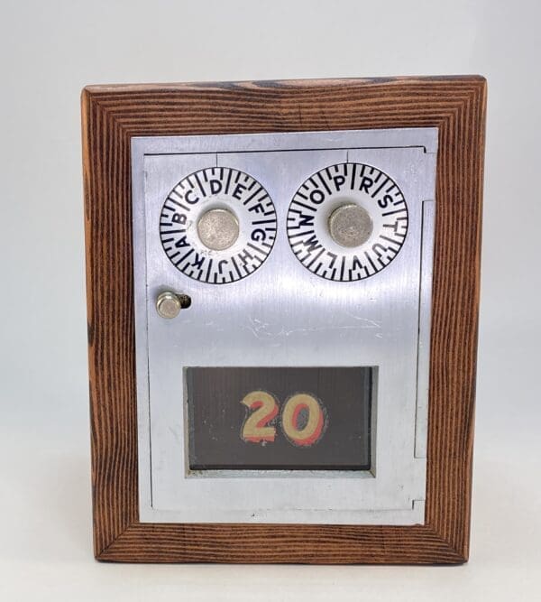 Wooden framed metal box with dials and number 20.