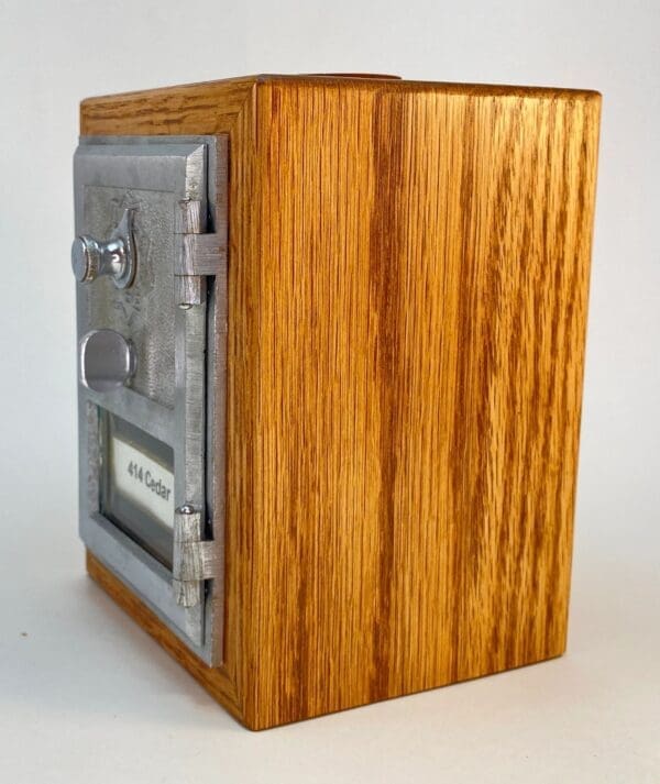 A wooden box with a metal door and lock.