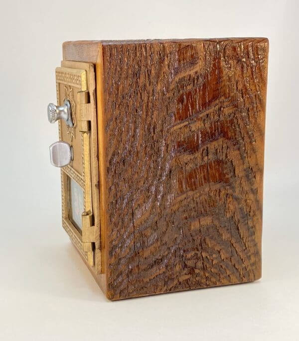 Vintage wooden mailbox with brass accents.