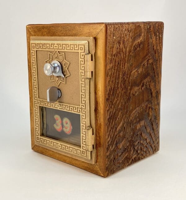 Vintage wooden mailbox with brass trim.