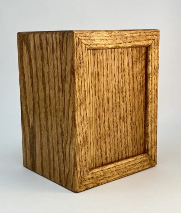 Wooden square box with grain pattern.