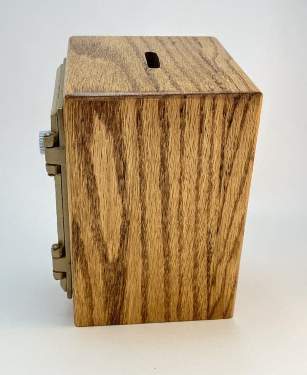 Wooden box with metal hinges and slot.