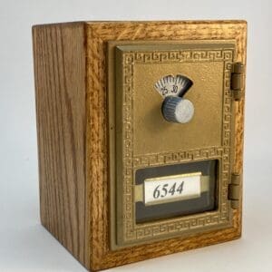 Wooden framed antique brass mailbox.