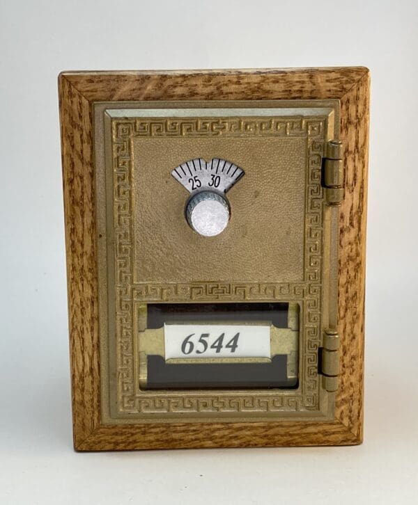 Antique brass mailbox with number 6544.