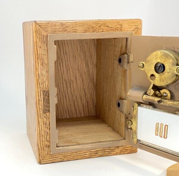 Wooden safe with open door and brass lock.