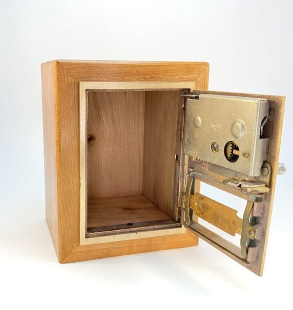 Wooden box with open metal door.