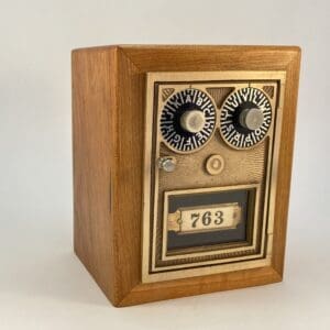 Wooden box with numbered dials and door.