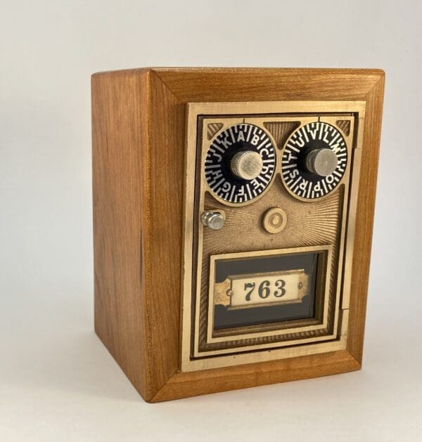 Wooden box with numbered dials and door.